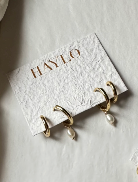 Dainty earring stack with drop pearl earring hoops in gold