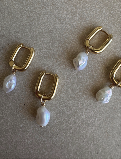 A pair of chunk gold earrings with pearls