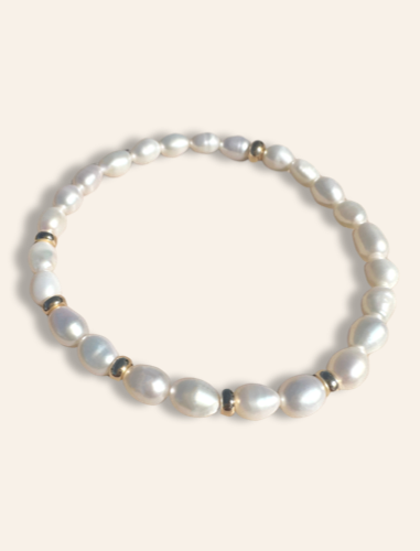 Everyday jewelry featuring a beaded bracelet with gold beads and pearls