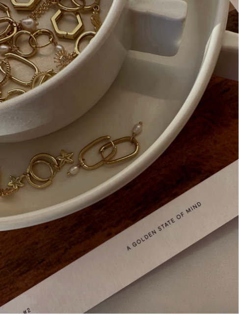 Everyday gold jewellery featuring gold starfish hoops and dainty rectangle drop hoops with mini pearls